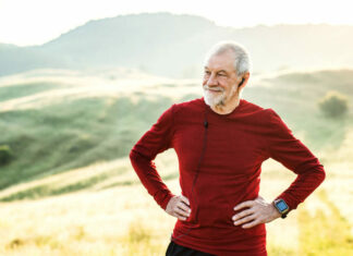 High-intensity exercise can boost motor skill learning in older adults A senior man resting during exercise, taking in a view of hills.