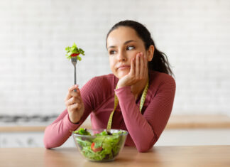 Psychologist Reveals How to Train Your Brain to Eat a Healthier Diet Woman eating salad