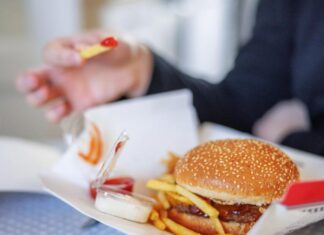 These Are the Unhealthiest Fast Food Burgers in America, Study Finds burger and fries with dips on cardboard box delivered at home