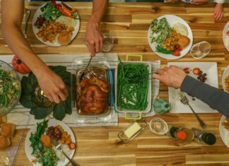 5 Ways to Keep Your Mental Health and Nutrition In Check This Thanksgiving Top-down view of a dining room table filled with food