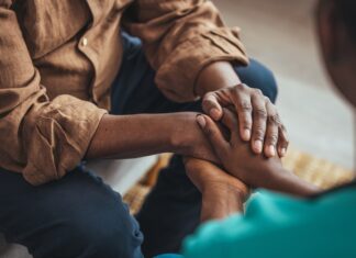 Annual Dementia Cases Are Anticipated to Double in the U.S. by 2060 A younger woman holds an older man’s hands.