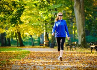 For a longer life, focus on healthy habits, not quick fixes woman in athletic clothes walking on outdoor trail