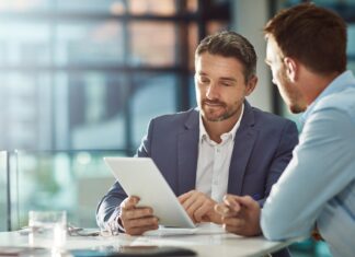 Older Americans find purpose and well-being in work, despite health barriers Teamwork meeting, tablet and business people in office workplace.