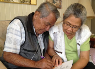 UH Center on Aging helps boost research pool for national study elder couple signing papers
