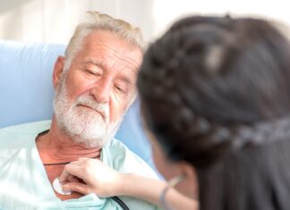 People living in low food, income areas have faster cognitive aging Nurse cares for elderly man lying in bed