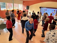 Council on Aging Celebrates Older Americans Month and Mental Health Awareness Month – DHSP A group of older adults dancing in a room at the Cambridge Senior Center